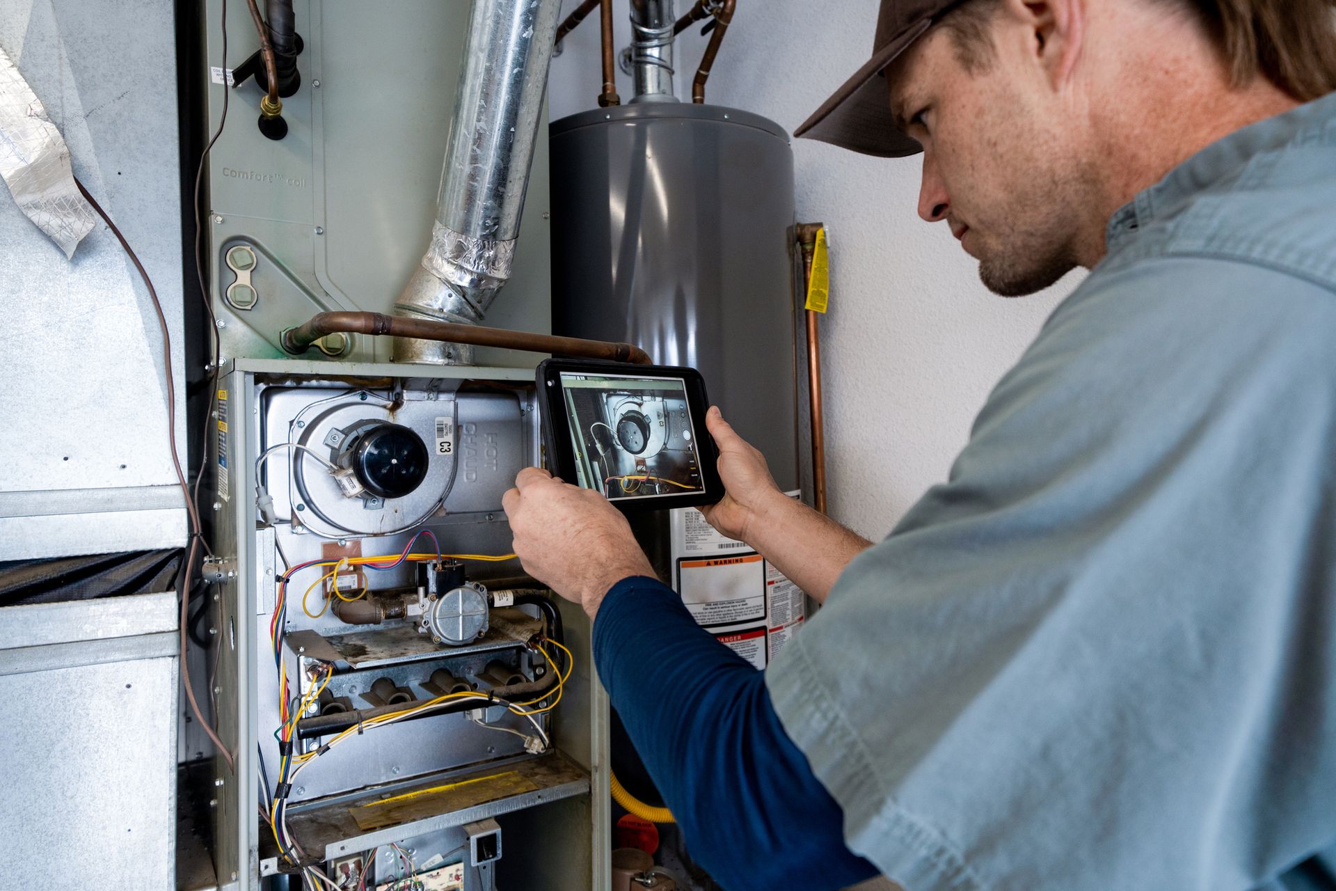 Technician working on a residential gas furnace