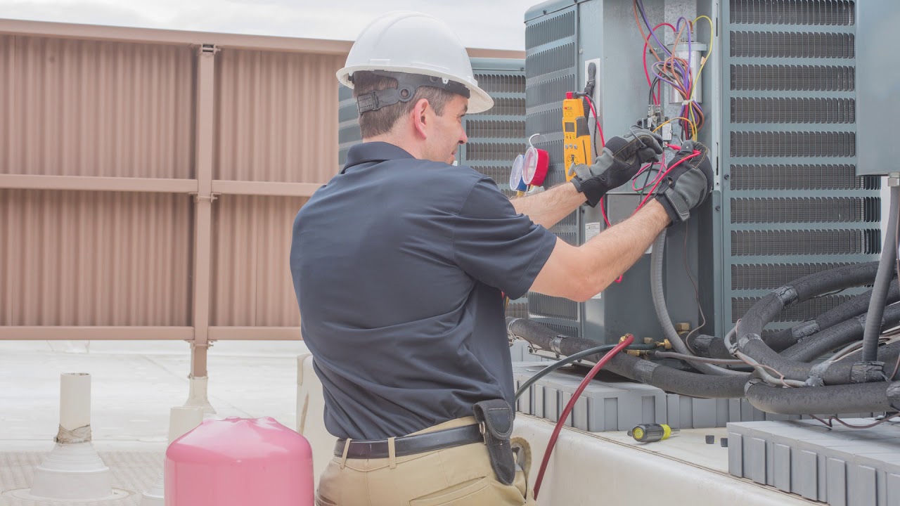 HVAC technician working on residential heating and cooling equipment